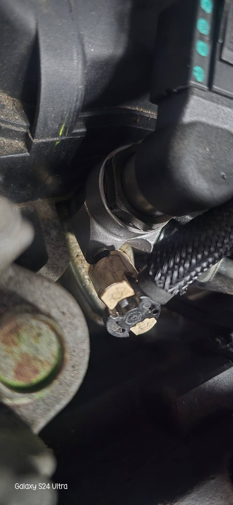 Close-up of automotive sensor and wiring repair